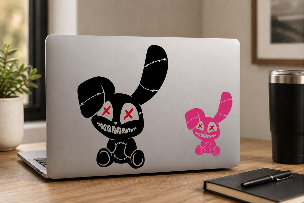 Creepy stitched bunny vinyl decal displayed on a laptop