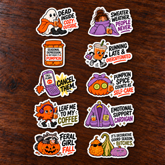 Ten separate fall stickers on a dark wood table featuring sarcastic coffee sayings, pumpkins, a ghost, raccoon and cozy sweater designs.